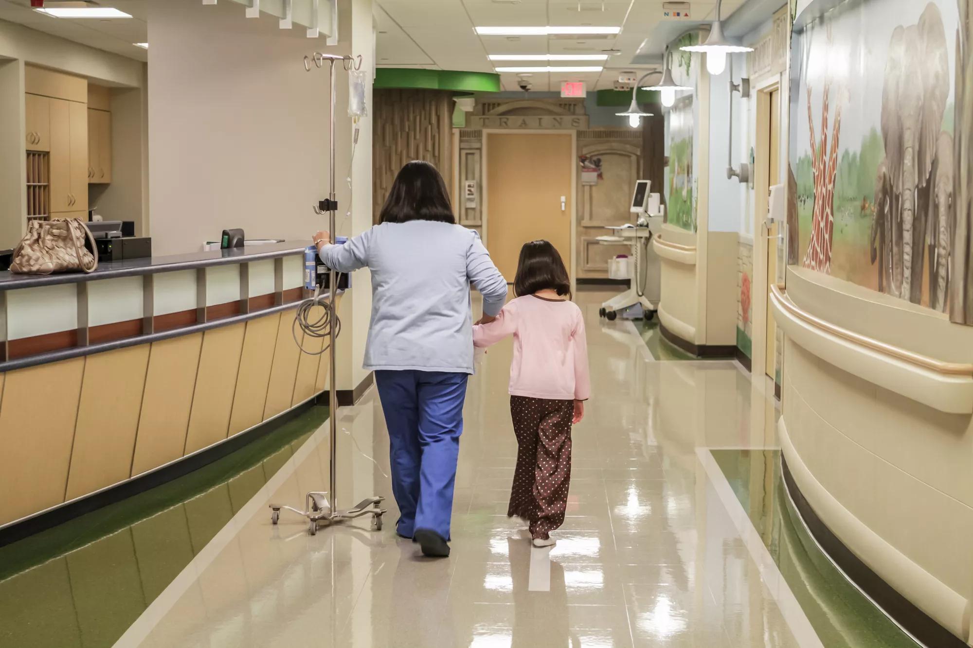 Nurse and girl walking in Hospital hallway, patient protection Securitas Healthcare.