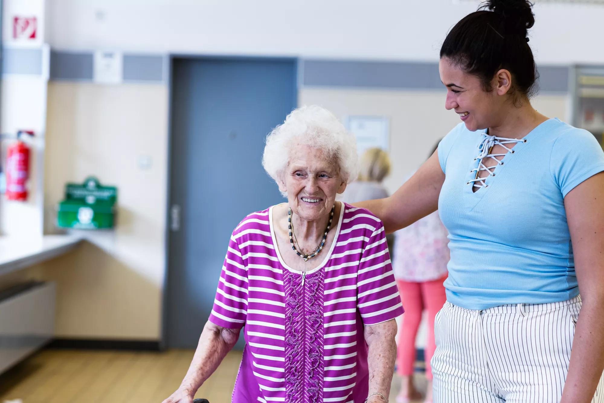 Care giver providing help to a senior in a resident community. Securitas Healthcare. 