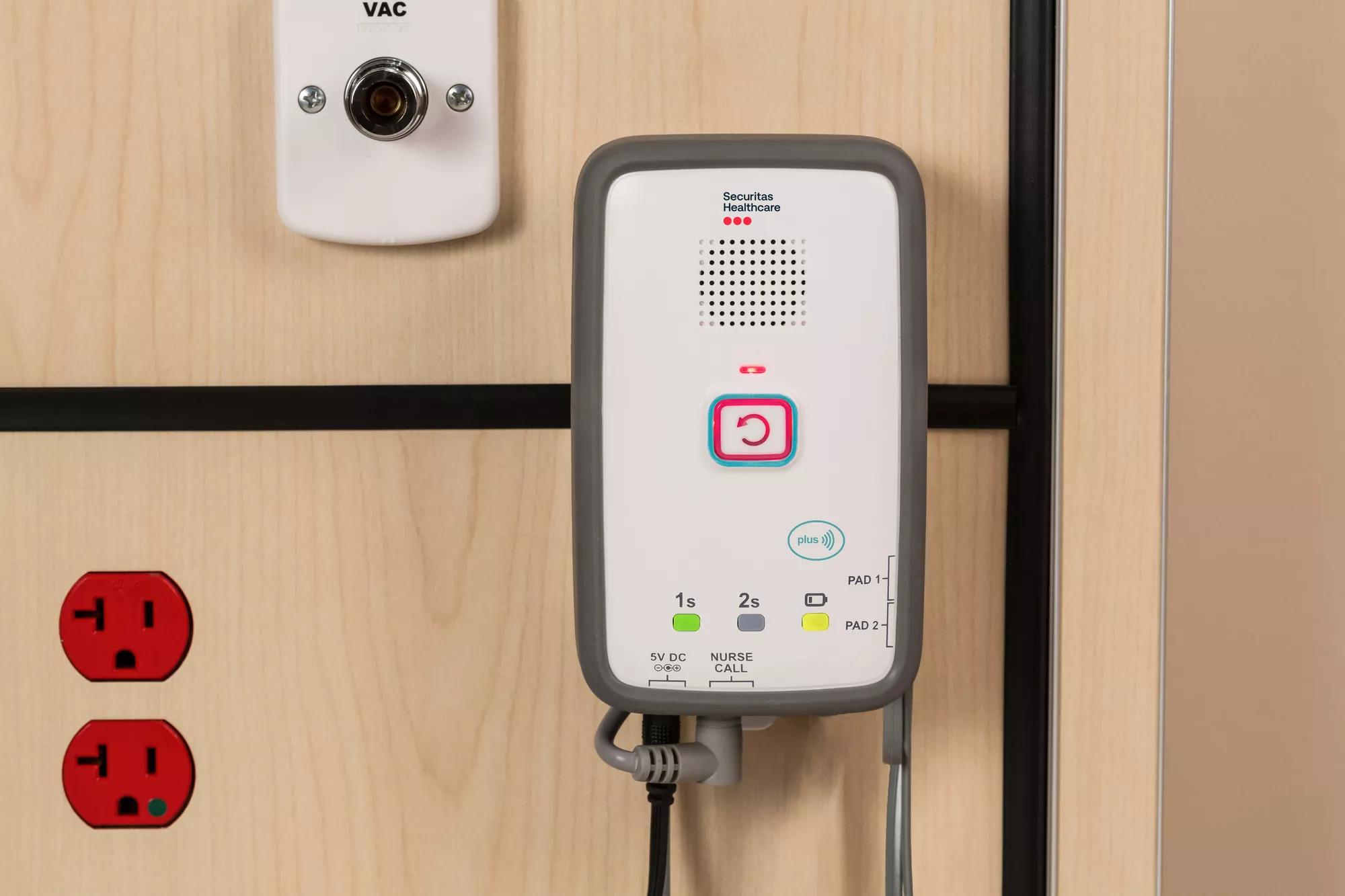 M210 fall monitor on headwall in hospital. Securitas Healthcare.