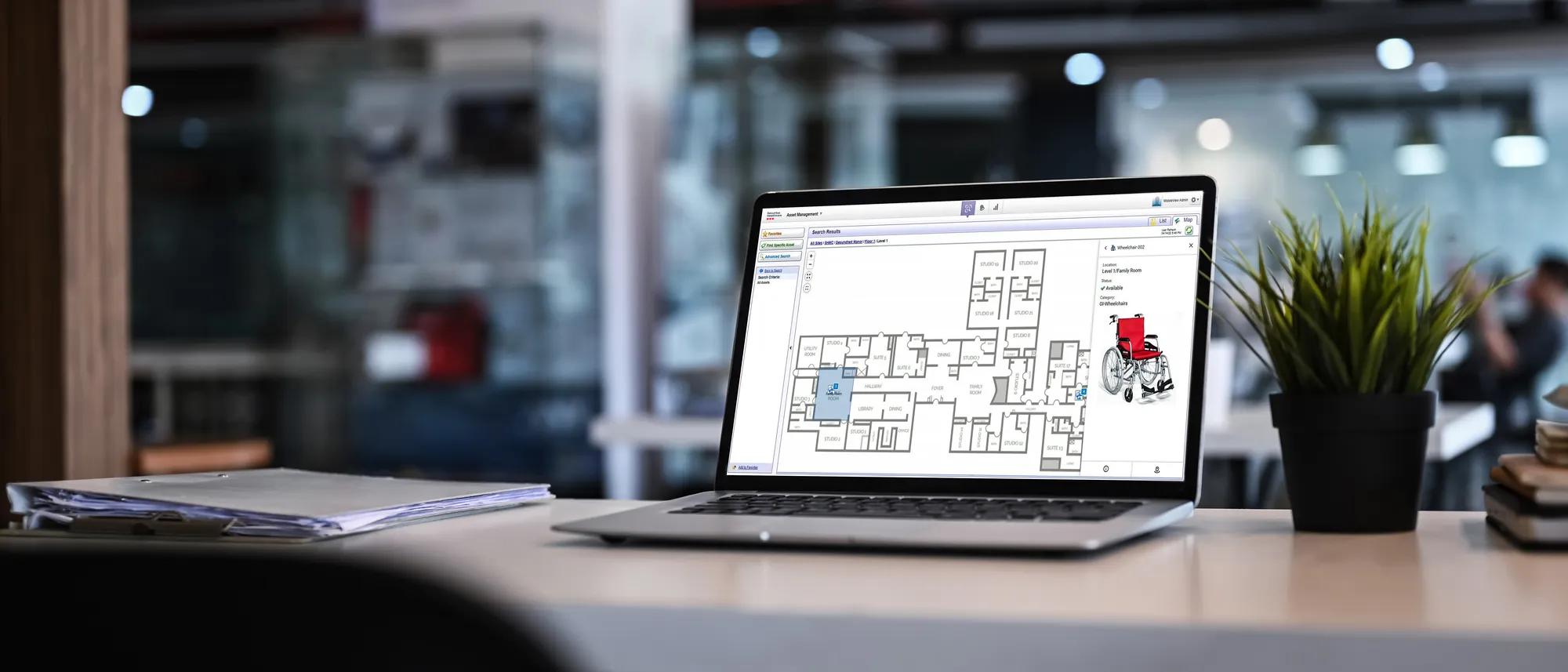 A laptop view of MobileView hospital asset management tracking on screen.