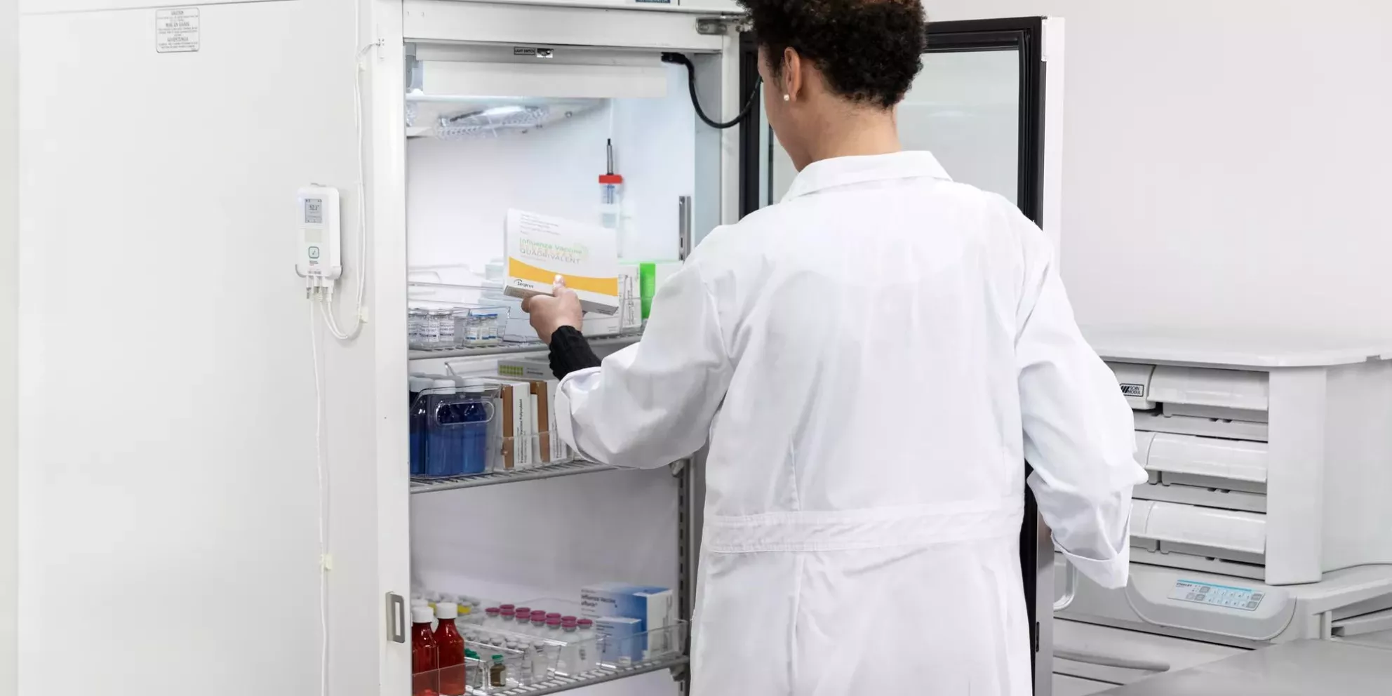 Retrieving vaccine from refrigerator monitored by Securitas Healthcare T15 tag