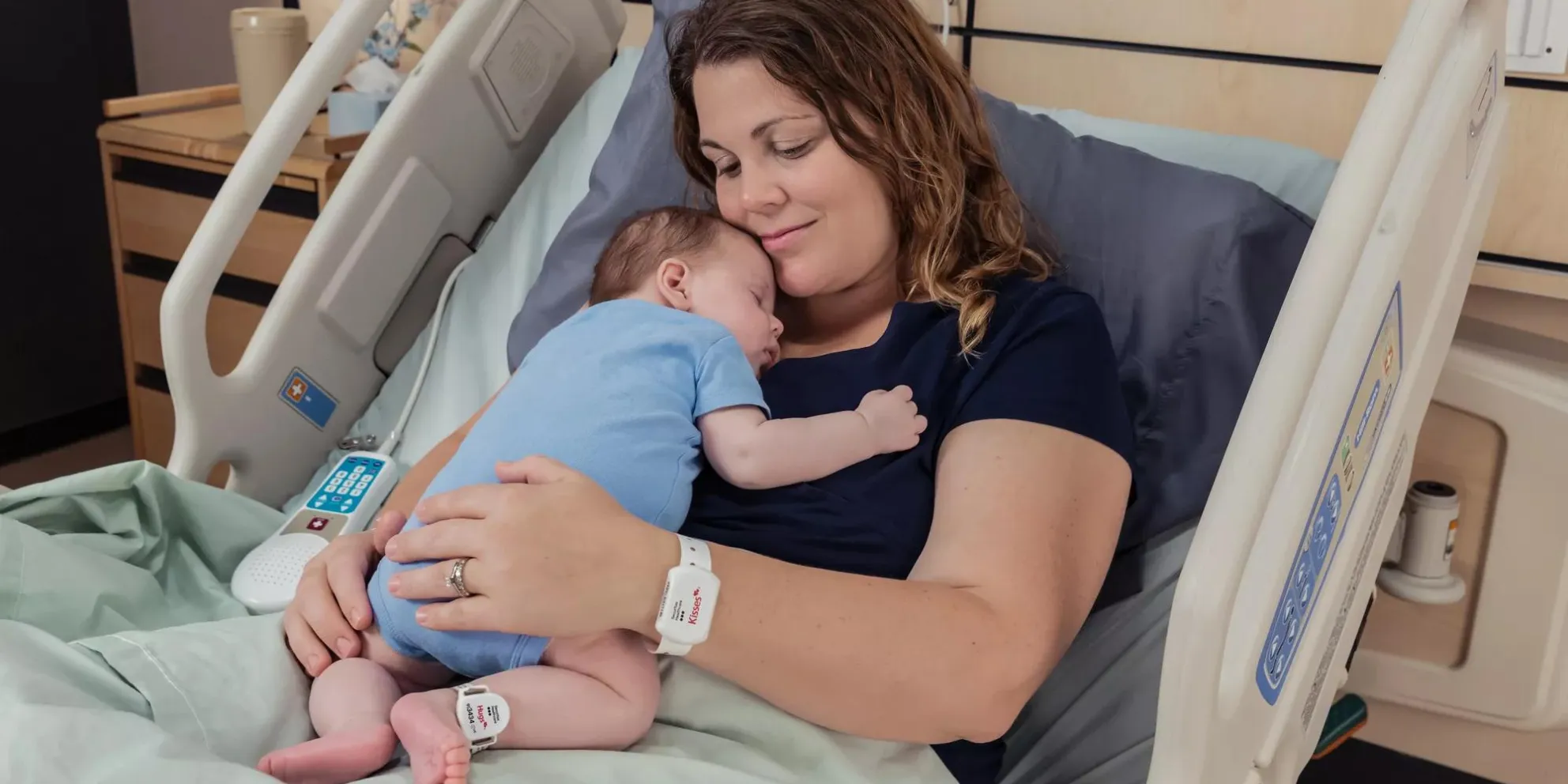 Baby and Mom utilizing the Kisses and Hugs infant protection - Securitas Healthcare.