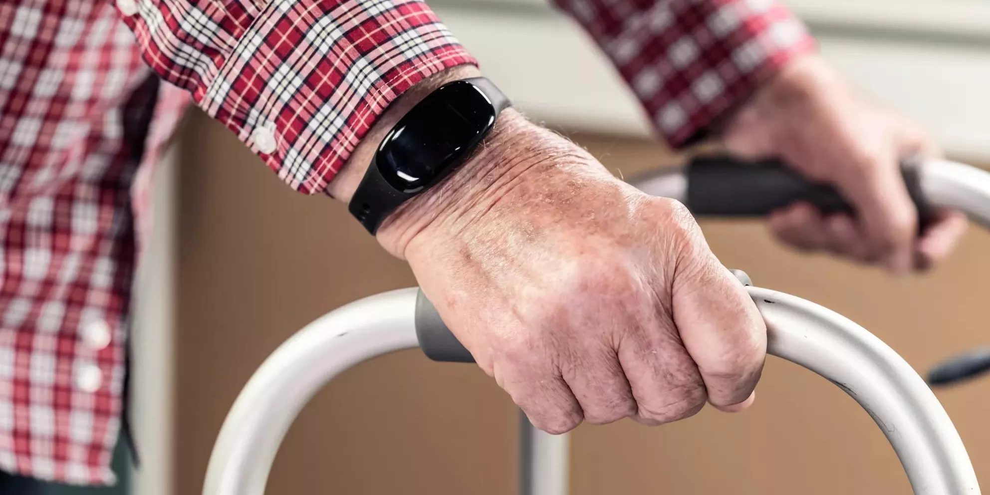 WanderGuard Blue on a wrist of senior living resident on a walker. Dementia care. Securitas Healthcare. 