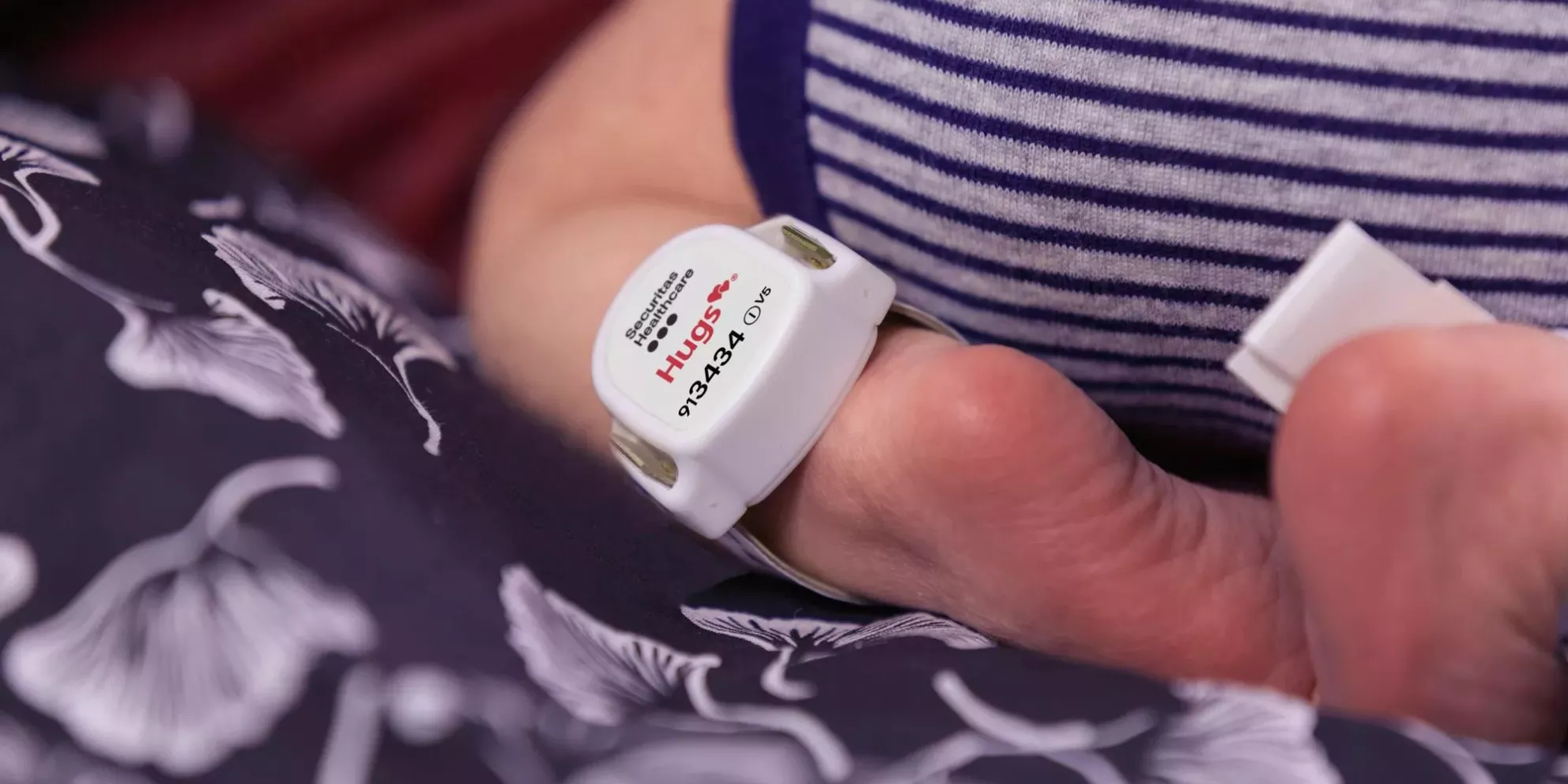 Hugs infant protection tag on a baby's ankle