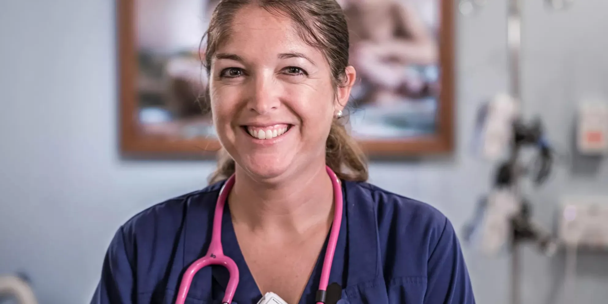 Smiling nurse knows she is protected using a hospital staff protection badge. Securitas Healthcare.