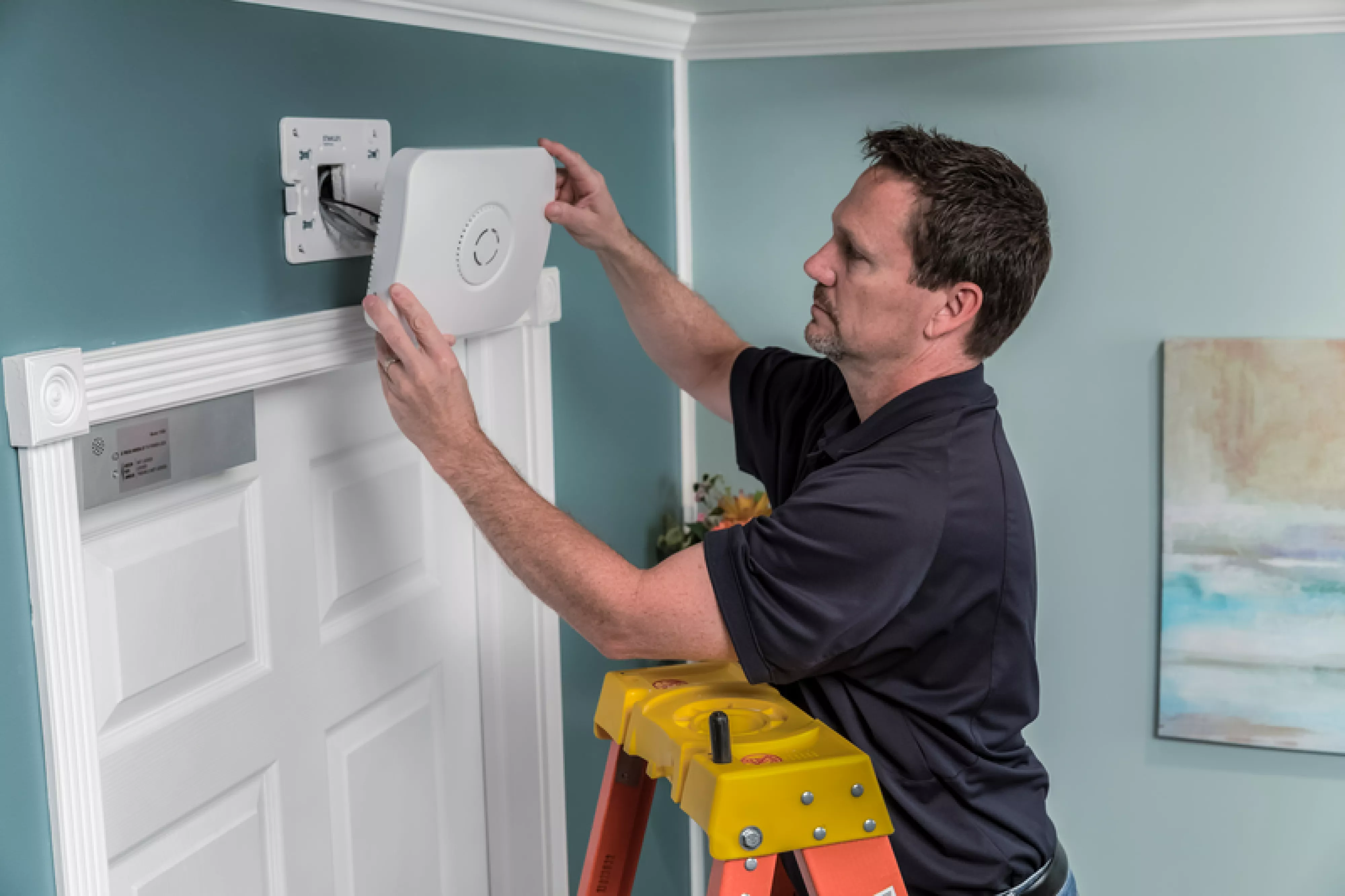 Securitas Healthcare technician installing a WandgerGuard Blue controller in a senior living community.