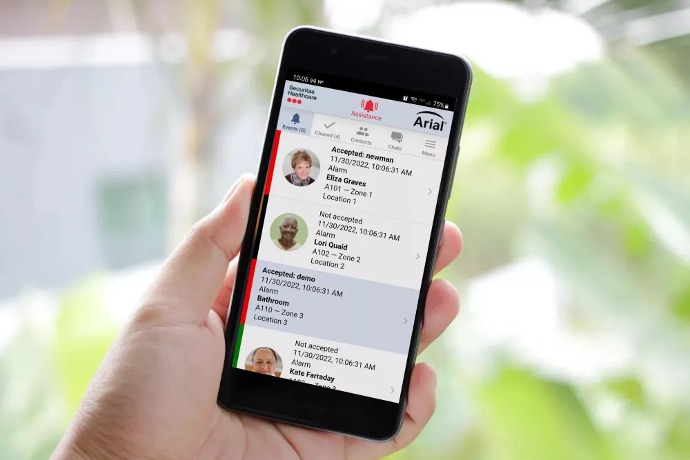 Hand holding phone with Arial mobile app by Securitas Healthcare