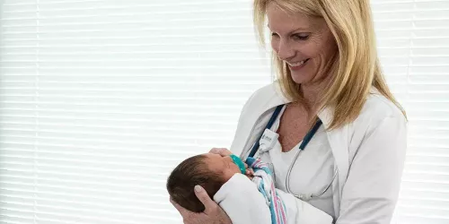 Nurse holding newborn baby