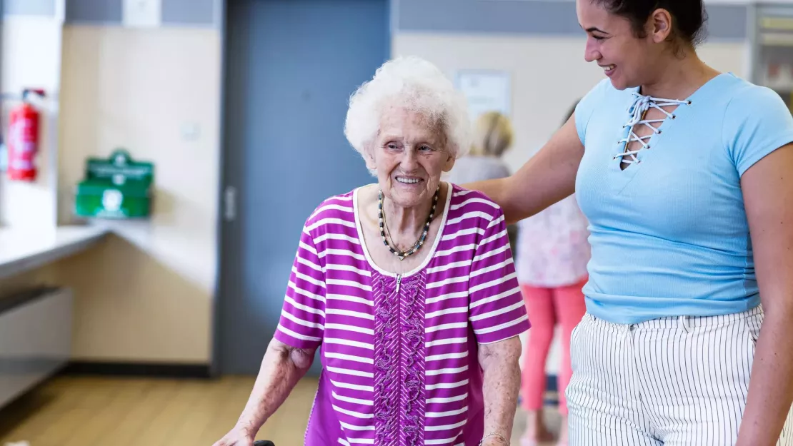 Care giver providing help to a senior in a resident community. Securitas Healthcare.
