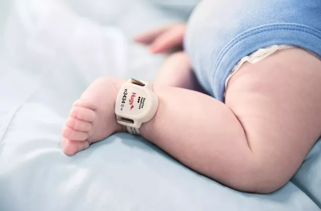 Securitas Healthcare Hugs infant protection tag attached to baby's ankle