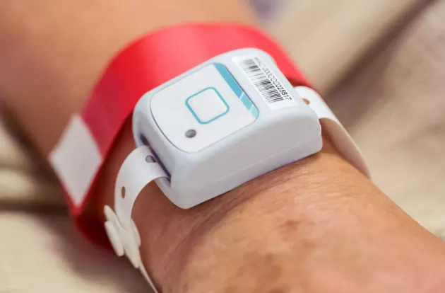 Patient wearing Securitas Healthcare's T2s Patient locating band on their wrist.