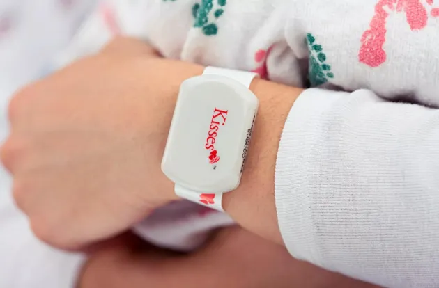 Closeup photo of Securitas Healthcare's Kisses Mother badge with mother-infant match technology.