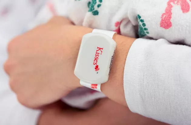 Closeup photo of Securitas Healthcare's Kisses Mother badge with mother-infant match technology.