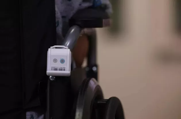 Securitas Healthcare's T12s Asset Management badge attached to the back of a wheelchair.