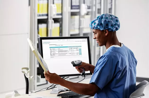 SpaceTRAX Hospital inventory management, while inventory is scanned and inventory is displayed on computer monitor. Securitas Healthcare.