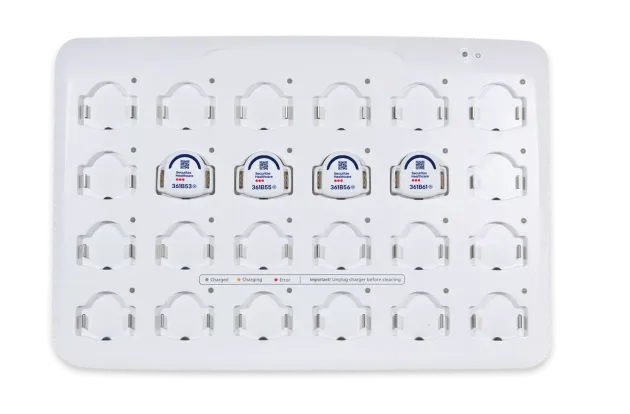 Four Securitas Healthcare T8p patient protection badges in the charging station.