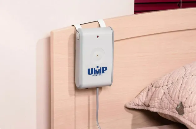 UMP Sentry Fall Monitor attached to a resident's headboard