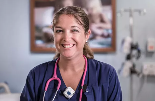 Caregiver smiling while wearing Securitas Healthcare's T14 staff badge.