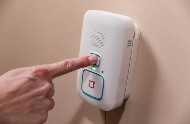 Arial Wi-Fi call station shown being pressed to call for help in a Senior living community. Securitas Healthcare. 