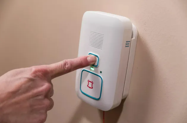 Arial Wi-Fi call station shown being pressed to call for help in a Senior living community. Securitas Healthcare. 