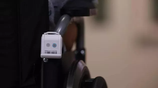 Securitas Healthcare's T12s Asset Management badge attached to the back of a wheelchair.