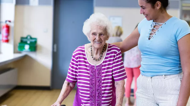 Care giver providing help to a senior in a resident community. Securitas Healthcare. 