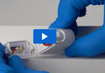 Gloved hands changing the battery in the T12sb tag