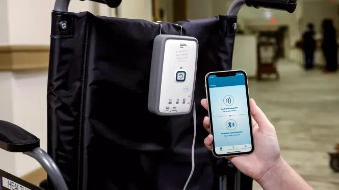 M210 fall management monitor attached to wheelchair with mobile app - Securitas Healthcare.