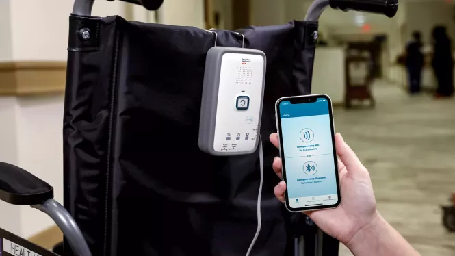M210 fall management monitor attached to wheelchair with mobile app - Securitas Healthcare.