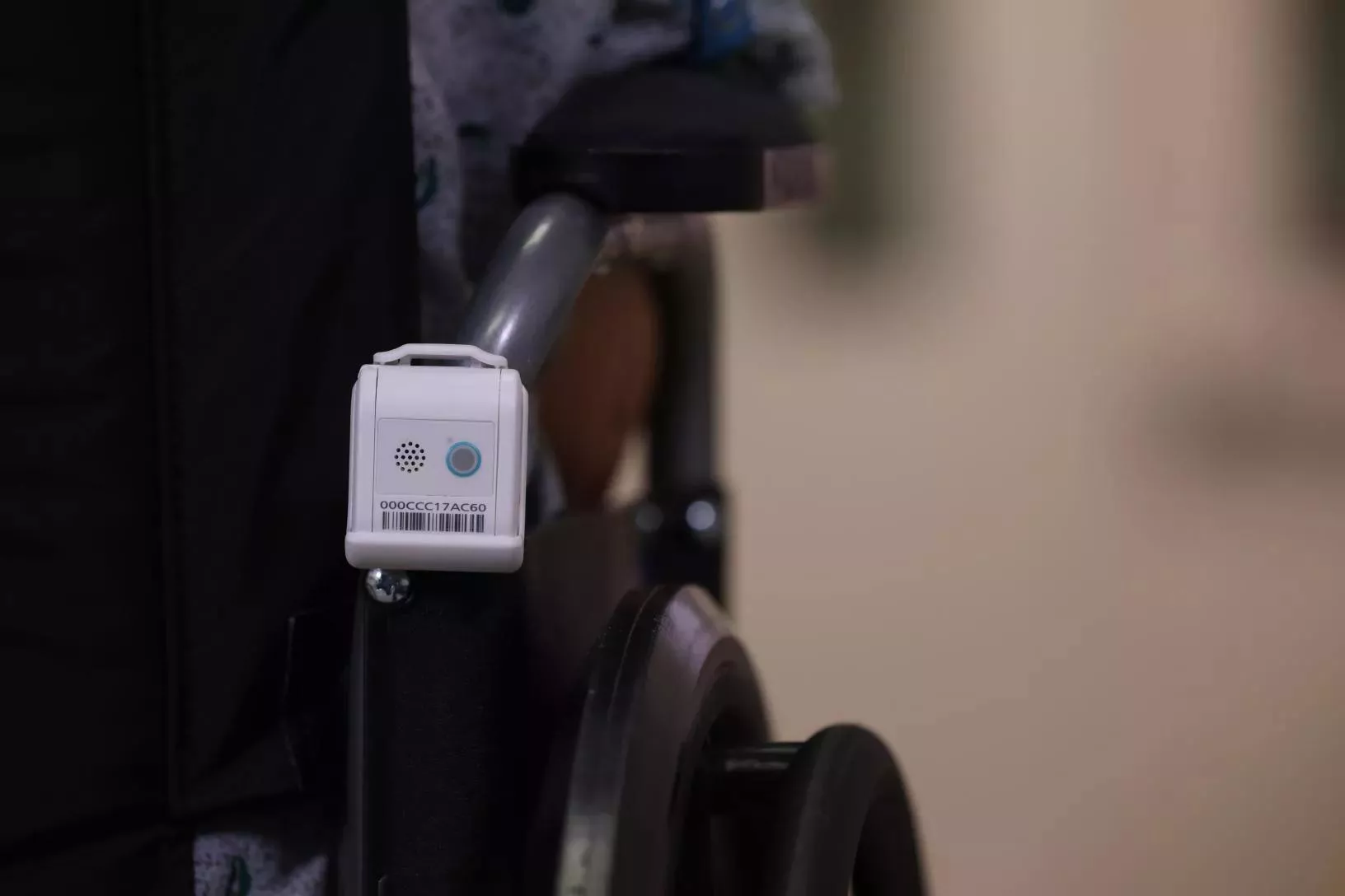 Securitas Healthcare's T12s Asset Management badge attached to the back of a wheelchair.