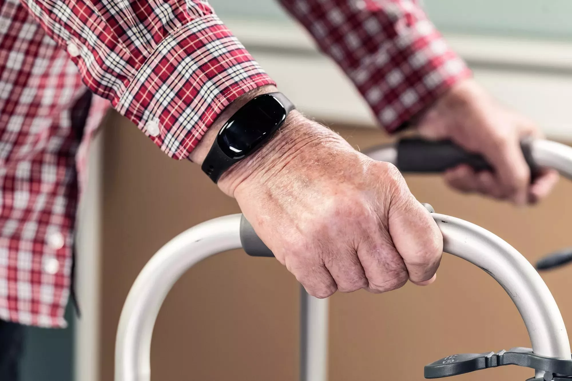 WanderGuard Blue on a wrist of senior living resident on a walker. Dementia care. Securitas Healthcare. 