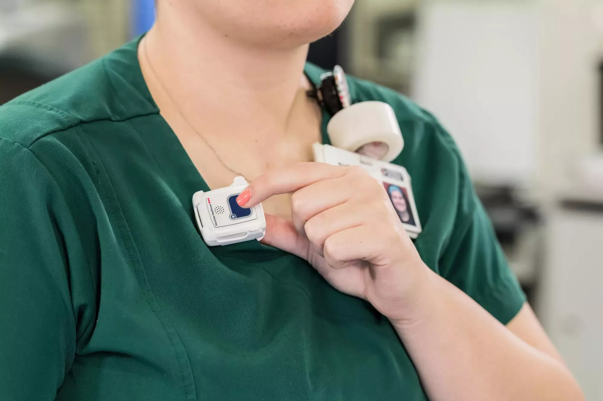 Staff protection badge being shown while the button is pressed. Securitas Healthcare.