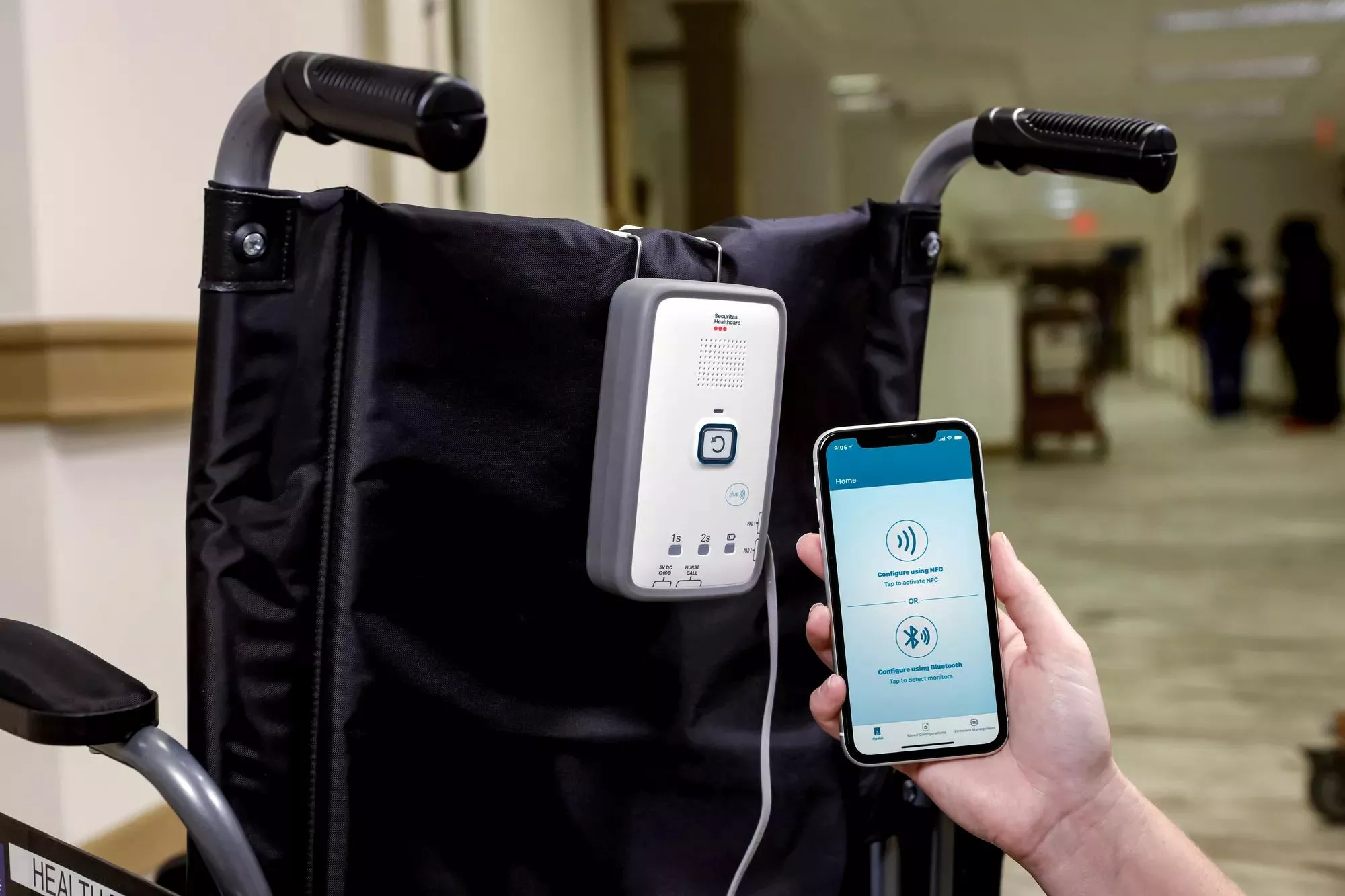 M210 fall management monitor attached to wheelchair with mobile app - Securitas Healthcare.