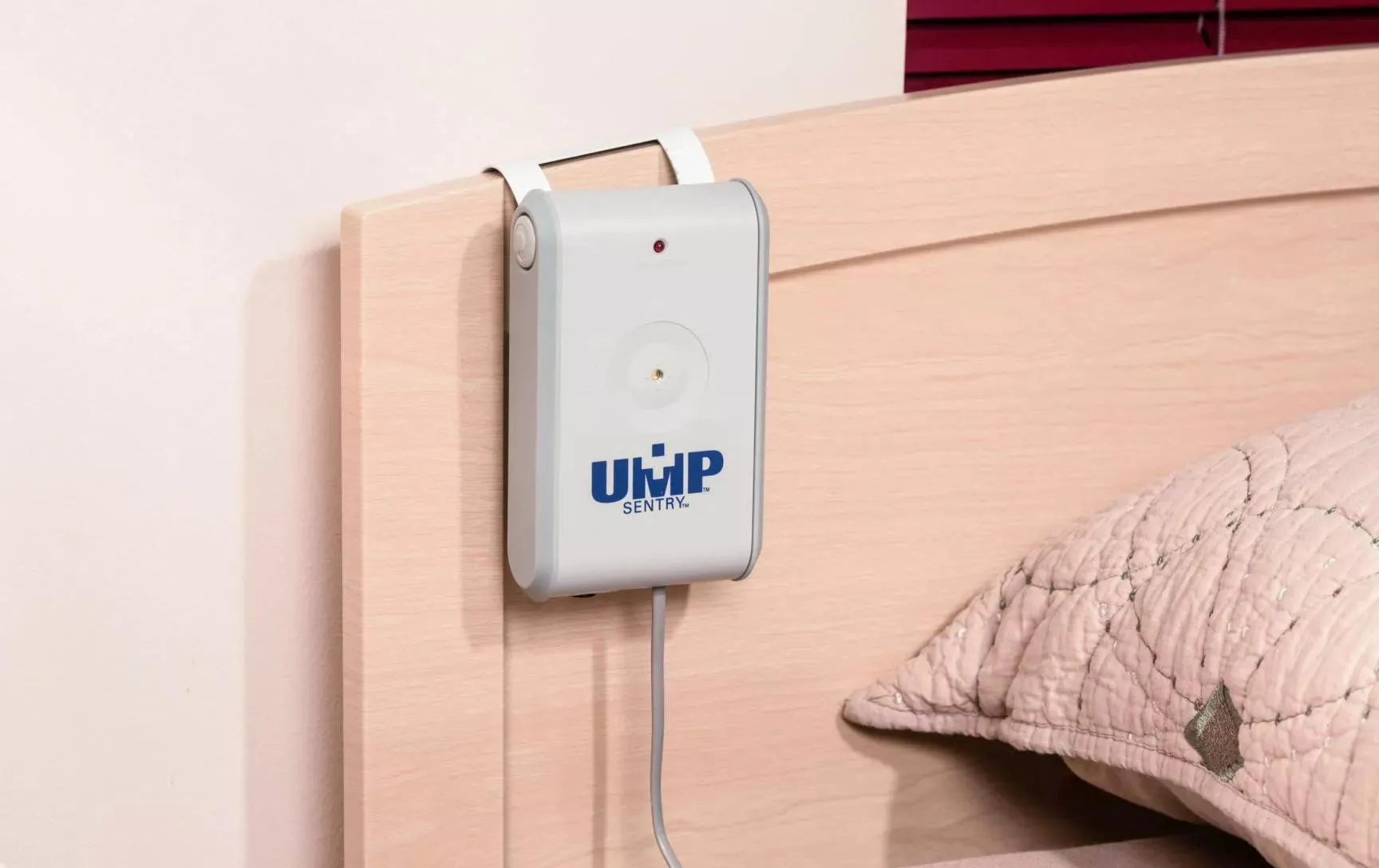 UMP Sentry Fall Monitor attached to a resident's headboard