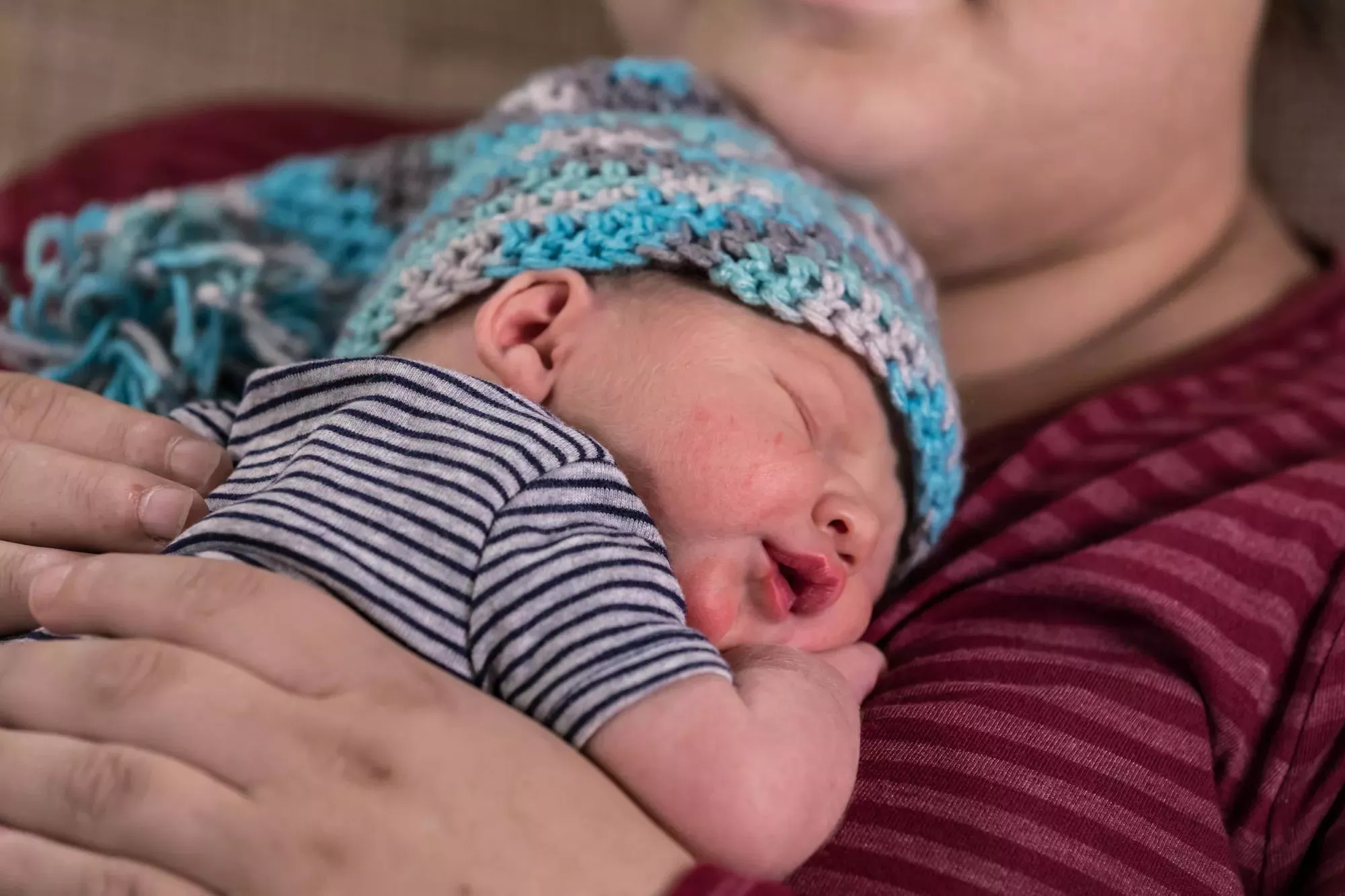 Newborn baby sleeping on Mom. Hugs Infant protection Securitas Healthcare.