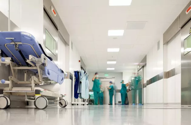 Blurred figures of people with medical uniforms in hospital corridor