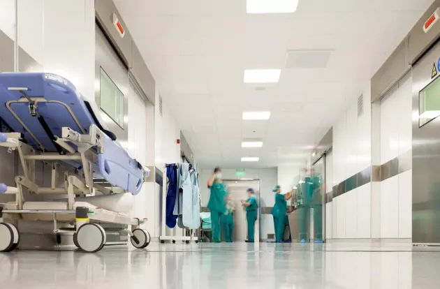 Blurred figures of people with medical uniforms in hospital corridor