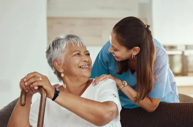 Senior living resident wearing WanderGuard BLUE bracelet is greeted by a community caregiver. Securitas Healthcare