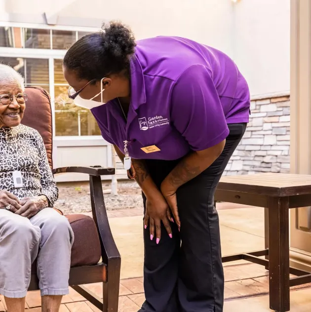 Caregiver checking on senior living resident wearing Arial Wi-Fi pendant. Securitas Healthcare.