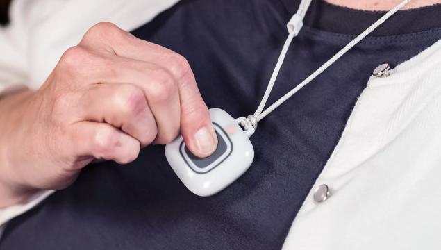 Securitas Healthcare, Arial wireless pendant being pressed. A nurse call solution for senior living facilities.