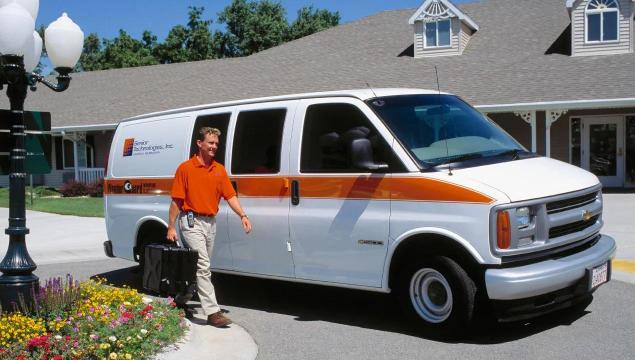 A vintage look at a Field Service Program technician and van, servicing the WanderGuard wander management solution. Securitas Healthcare.