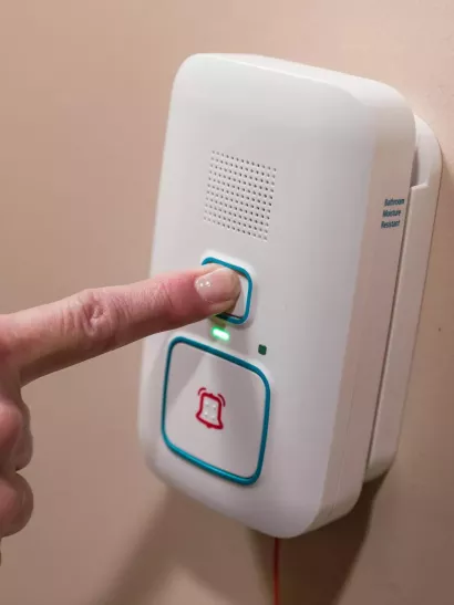 Arial Wi-Fi call station shown being pressed to call for help in a Senior living community. Securitas Healthcare.