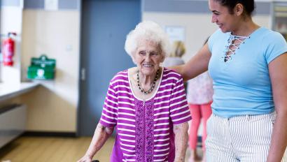 Care giver providing help to a senior in a resident community. Securitas Healthcare. 