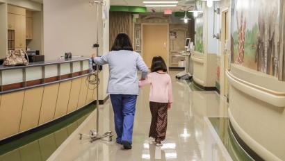 Nurse and girl walking in Hospital hallway, patient protection Securitas Healthcare.