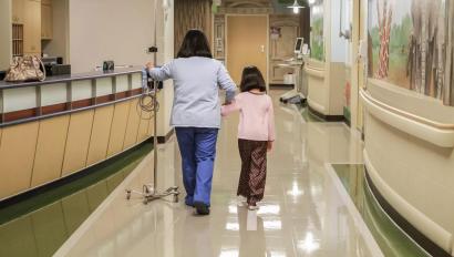 Nurse and girl walking in Hospital hallway, patient protection Securitas Healthcare.