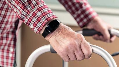 WanderGuard Blue on a wrist of senior living resident on a walker. Dementia care. Securitas Healthcare. 