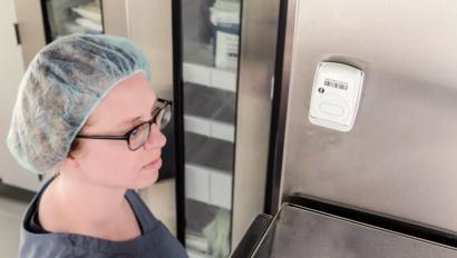 Caregiver checking Securitas Healthcare's T5a temperature monitoring sensor.